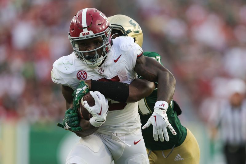 Sep 16, 2023; Tampa, Florida, USA;  Alabama Crimson Tide running back Roydell Williams (5) is tackled by South Florida Bulls safety Logan Berryhill (37) in the third quarter at Raymond James Stadium. Mandatory Credit: Nathan Ray Seebeck-USA TODAY Sports