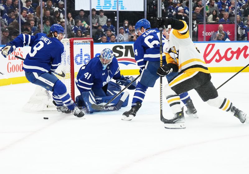 Oct 12, 2024; Toronto, Ontario, CAN; Toronto Maple Leafs center David Kampf (64) battles for the puck with Pittsburgh Penguins center Noel Acciari (55) during the second period at Scotiabank Arena. Mandatory Credit: Nick Turchiaro-Imagn Images