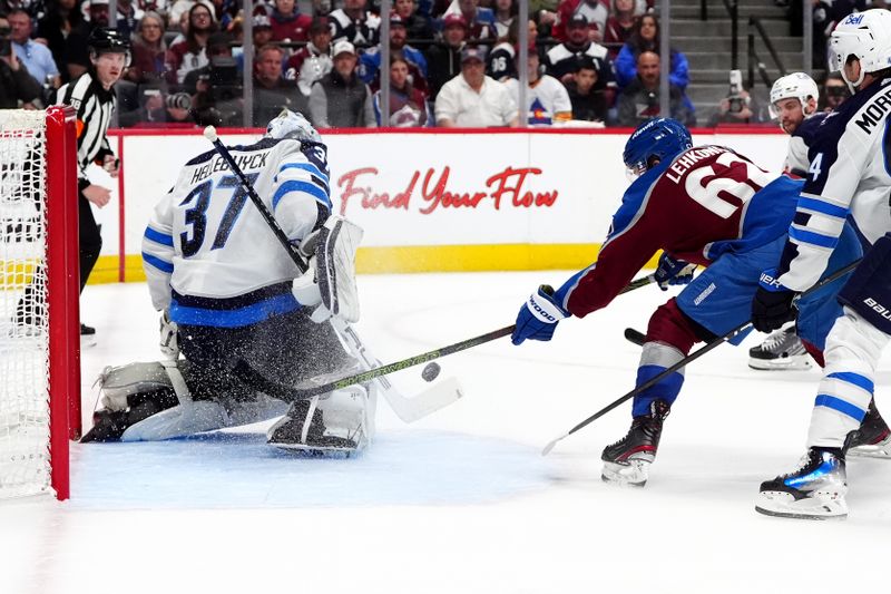 Apr 28, 2024; Denver, Colorado, USA; Colorado Avalanche left wing Artturi Lehkonen (62) shoots the puck at Winnipeg Jets goaltender Connor Hellebuyck (37) during the second period in game four of the first round of the 2024 Stanley Cup Playoffs at Ball Arena. Mandatory Credit: Ron Chenoy-USA TODAY Sports