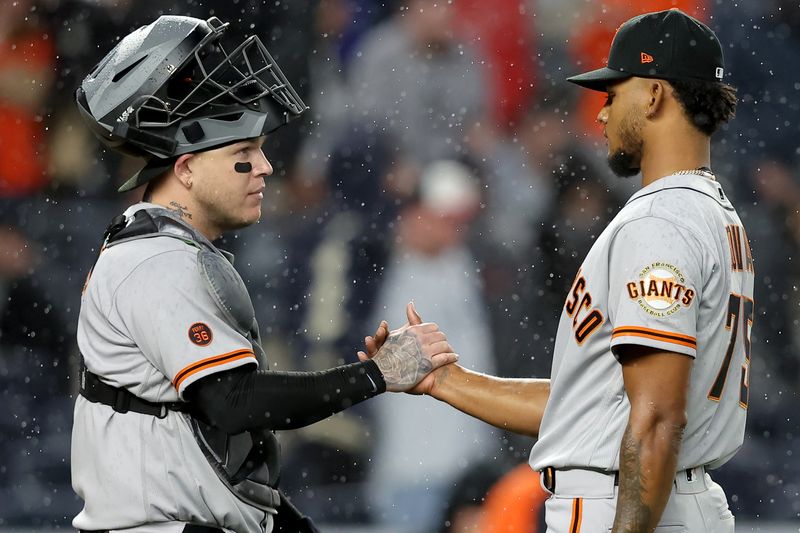 Apr 1, 2023; Bronx, New York, USA; San Francisco Giants relief pitcher Camilo Doval (75) shakes hands with catcher Roberto Perez (1) after defeating the New York Yankees at Yankee Stadium. Mandatory Credit: Brad Penner-USA TODAY Sports