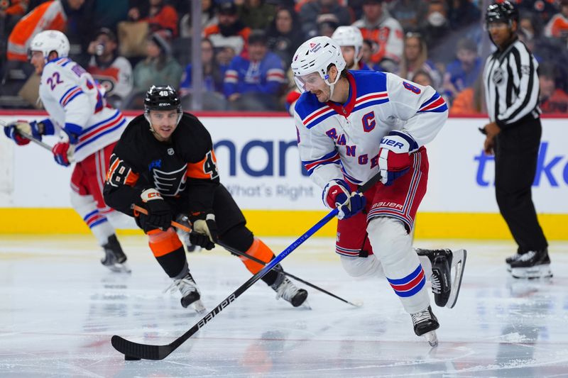 Nov 29, 2024; Philadelphia, Pennsylvania, USA; New York Rangers defenseman Jacob Trouba (8) controls the puck against the Philadelphia Flyers in the third period at Wells Fargo Center. Mandatory Credit: Kyle Ross-Imagn Images