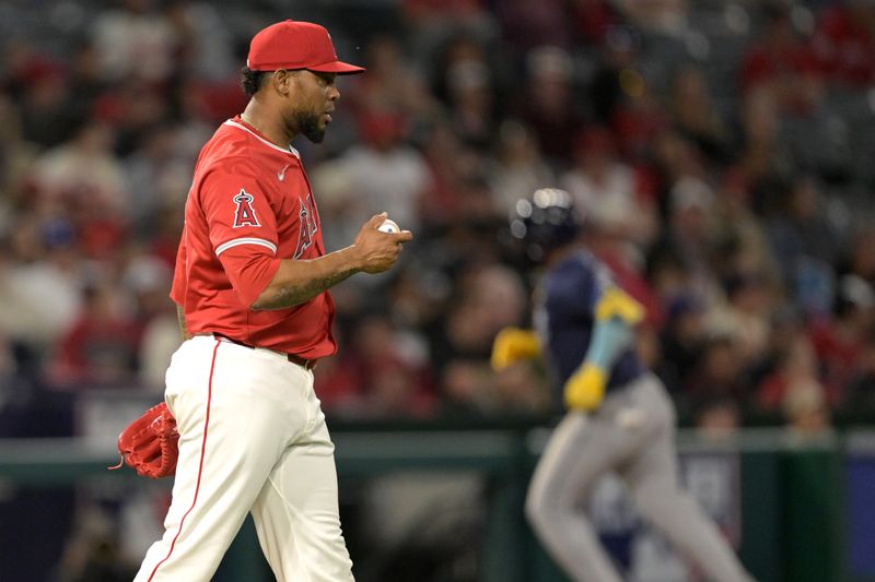 Apr 9, 2024; Anaheim, California, USA;  Los Angeles Angels pitcher Jose Cisnero (67) checks the ball after giving up a solo home run to Tampa Bay Rays third base Isaac Paredes (17) in the seventh inning at Angel Stadium. Mandatory Credit: Jayne Kamin-Oncea-USA TODAY Sports