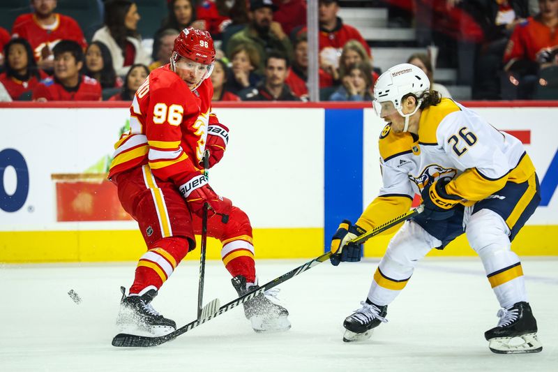 Nov 15, 2024; Calgary, Alberta, CAN; Calgary Flames left wing Andrei Kuzmenko (96) and Nashville Predators center Philip Tomasino (26) battles for the puck during the second period at Scotiabank Saddledome. Mandatory Credit: Sergei Belski-Imagn Images