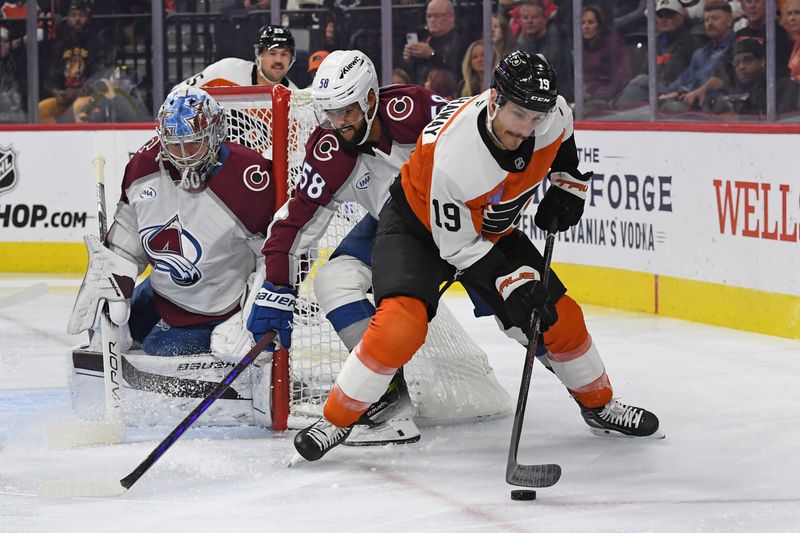 Nov 18, 2024; Philadelphia, Pennsylvania, USA; Philadelphia Flyers right wing Garnet Hathaway (19) controls the puck against Colorado Avalanche defenseman Oliver Kylington (58) during the first period at Wells Fargo Center. Mandatory Credit: Eric Hartline-Imagn Images