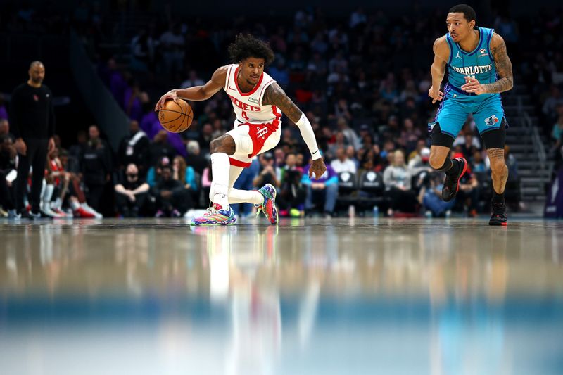 CHARLOTTE, NORTH CAROLINA - JANUARY 26: Jalen Green #4 of the Houston Rockets dribbles against Nick Smith Jr. #8 of the Charlotte Hornets during the second quarter of the game at Spectrum Center on January 26, 2024 in Charlotte, North Carolina. NOTE TO USER: User expressly acknowledges and agrees that, by downloading and or using this photograph, User is consenting to the terms and conditions of the Getty Images License Agreement. (Photo by Jared C. Tilton/Getty Images)