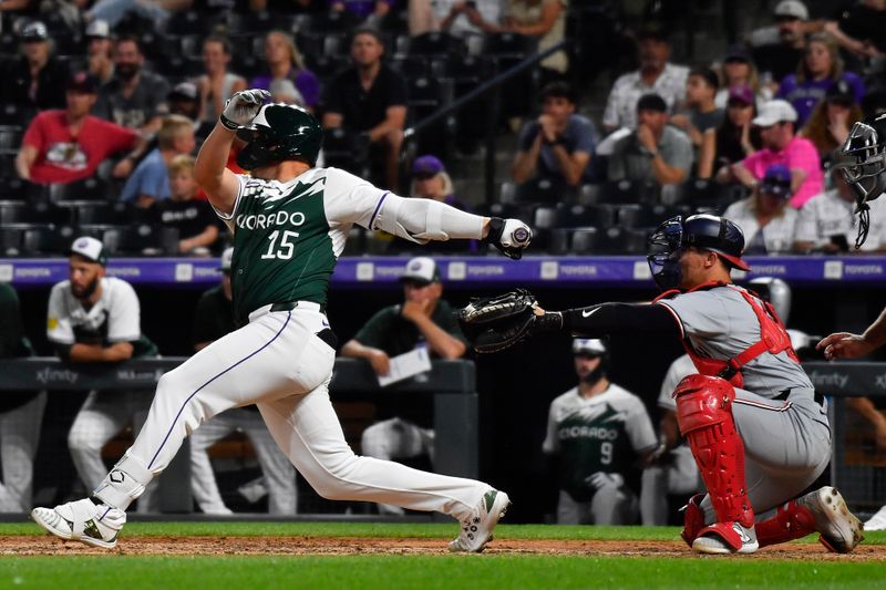 Jun 22, 2024; Denver, Colorado, USA; Colorado Rockies designated hitter Hunter Goodman (15) hits a single against the Washington Nationals in the ninth inning at Coors Field. Mandatory Credit: John Leyba-USA TODAY Sports