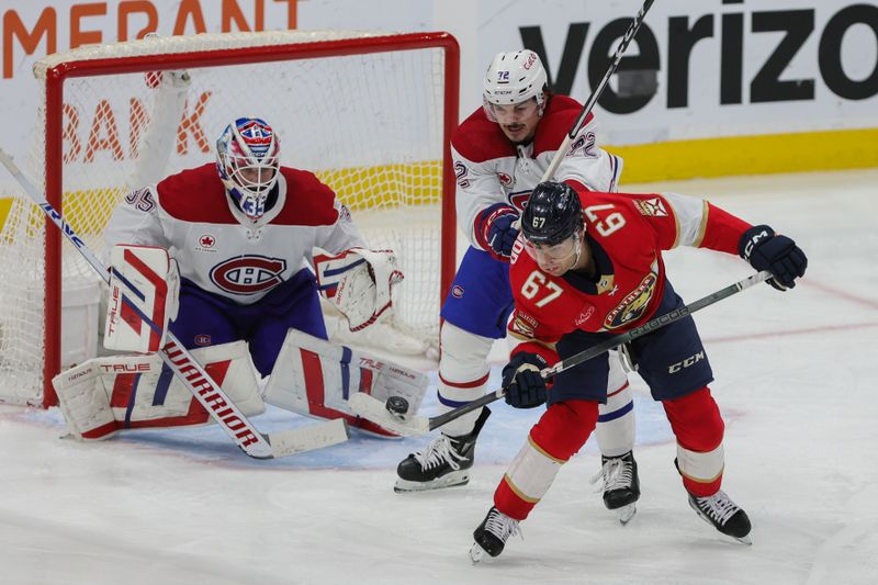 Feb 29, 2024; Sunrise, Florida, USA; Florida Panthers right wing William Lockwood (67) controls the puck against Montreal Canadiens defenseman Arber Xhekaj (72) during the third period at Amerant Bank Arena. Mandatory Credit: Sam Navarro-USA TODAY Sports