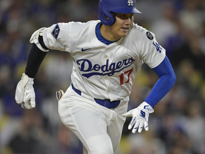 May 15, 2025; Los Angeles, California, USA;  Los Angeles Dodgers designated hitter Shohei Ohtani (17) runs to first on a single in the sixth inning against the Athletics at Dodger Stadium. Mandatory Credit: Jayne Kamin-Oncea-Imagn Images