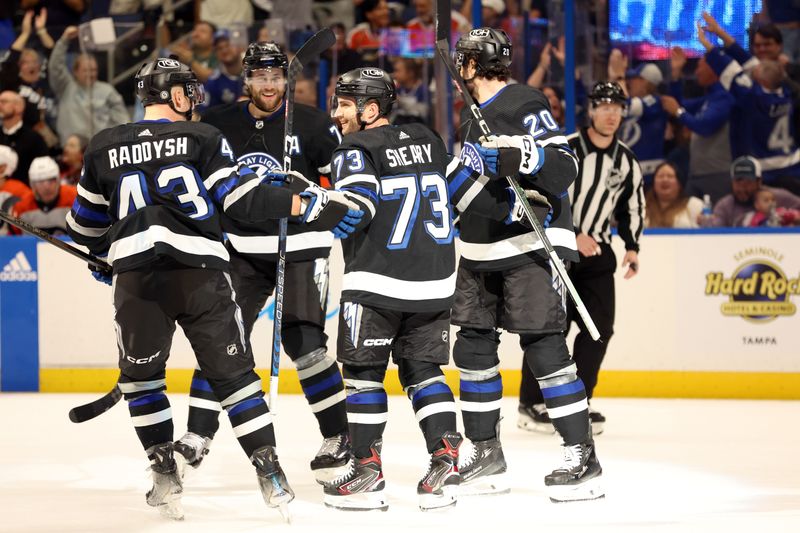 Mar 9, 2024; Tampa, Florida, USA; Tampa Bay Lightning left wing Conor Sheary (73) celebrates with defenseman Darren Raddysh (43), defenseman Victor Hedman (77) and  left wing Nicholas Paul (20) after scoring a goal against the Philadelphia Flyers during the first period at Amalie Arena. Mandatory Credit: Kim Klement Neitzel-USA TODAY Sports