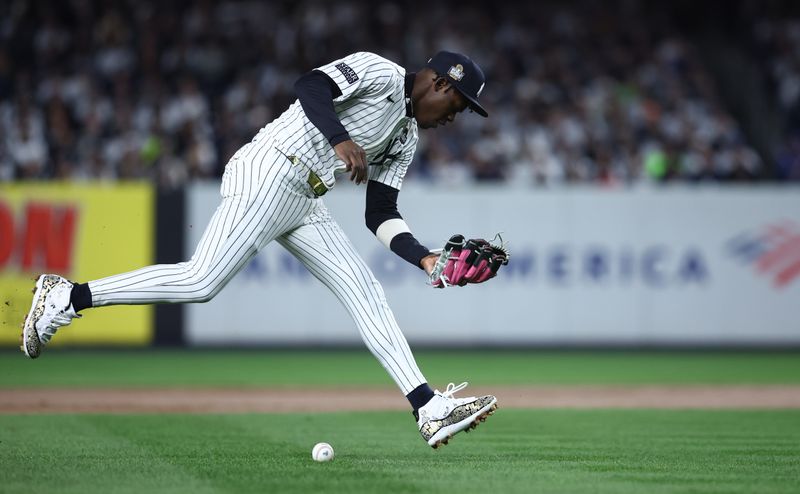 Oct 28, 2024; New York, New York, USA; New York Yankees third baseman Jazz Chisholm Jr. (13) makes a fielding error during the fifth inning against the Los Angeles Dodgers in game three of the 2024 MLB World Series at Yankee Stadium. Mandatory Credit: Wendell Cruz-Imagn Images