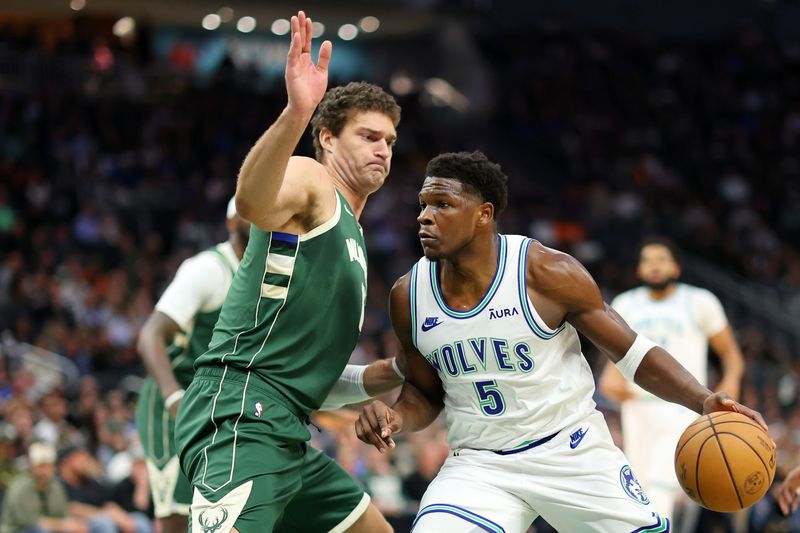 MILWAUKEE, WISCONSIN - FEBRUARY 08: Anthony Edwards #5 of the Minnesota Timberwolves drives to the basket against Brook Lopez #11 of the Milwaukee Bucks during the first half of a game at Fiserv Forum on February 08, 2024 in Milwaukee, Wisconsin. NOTE TO USER: User expressly acknowledges and agrees that, by downloading and or using this photograph, User is consenting to the terms and conditions of the Getty Images License Agreement. (Photo by Stacy Revere/Getty Images)