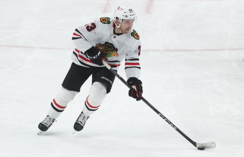 Apr 8, 2025; Pittsburgh, Pennsylvania, USA;  Chicago Blackhawks center Philipp Kurashev (23) skates with the puck against the Pittsburgh Penguins during the second period at PPG Paints Arena. Mandatory Credit: Charles LeClaire-Imagn Images