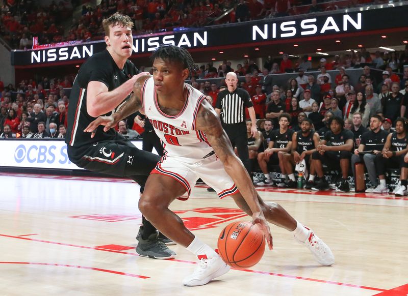 Jan 28, 2023; Houston, Texas, USA; Houston Cougars guard Marcus Sasser (0) dribbles against Cincinnati Bearcats forward Viktor Lakhin (30) in the second half at Fertitta Center. Houston Cougars won 75 to 69 .Mandatory Credit: Thomas Shea-USA TODAY Sports