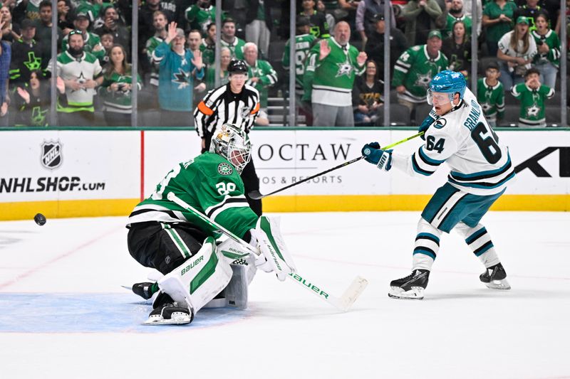 Oct 15, 2024; Dallas, Texas, USA; San Jose Sharks center Mikael Granlund (64) scores a goal against Dallas Stars goaltender Jake Oettinger (29) during the overtime shootout period at the American Airlines Center. Mandatory Credit: Jerome Miron-Imagn Images