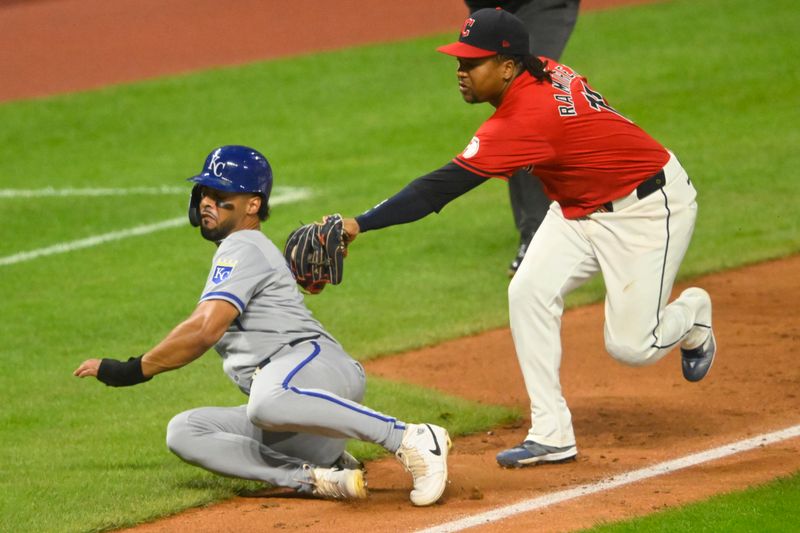 Aug 27, 2024; Cleveland, Ohio, USA; Kansas City Royals left fielder MJ Melendez (1) is tagged out by Cleveland Guardians third baseman Jose Ramirez (11) during a rundown in the seventh inning at Progressive Field. Mandatory Credit: David Richard-USA TODAY Sports