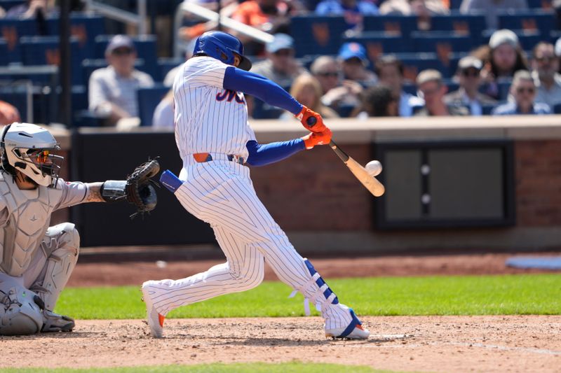 May 1, 2025; New York City, New York, USA; New York Mets right fielder Juan Soto (22) hits a home run against the Arizona Diamondbacks during the sixth inning at Citi Field. Mandatory Credit: Gregory Fisher-Imagn Images