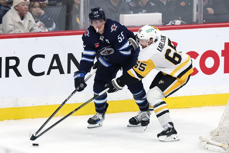 Nov 1, 2025; Winnipeg, Manitoba, CAN; Winnipeg Jets center Mark Scheifele (55) is checked by Pittsburgh Penguins defenseman Erik Karlsson (65) in the third period at Canada Life Centre. Mandatory Credit: James Carey Lauder-Imagn Images Nov 1, 2025; Winnipeg, Manitoba, CAN; Winnipeg Jets center Mark Scheifele (55) is checked by Pittsburgh Penguins defenseman Erik Karlsson (65) in the third period at Canada Life Centre. Mandatory Credit: James Carey Lauder-Imagn Images