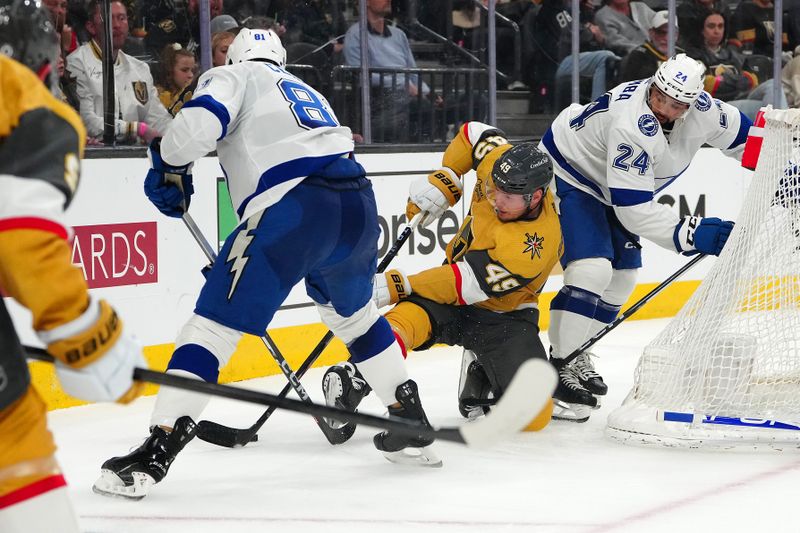 Mar 19, 2024; Las Vegas, Nevada, USA; Vegas Golden Knights center Ivan Barbashev (49) attempts to control the puck between Tampa Bay Lightning defenseman Erik Cernak (81) and Tampa Bay Lightning defenseman Matt Dumba (24) during the second period at T-Mobile Arena. Mandatory Credit: Stephen R. Sylvanie-USA TODAY Sports