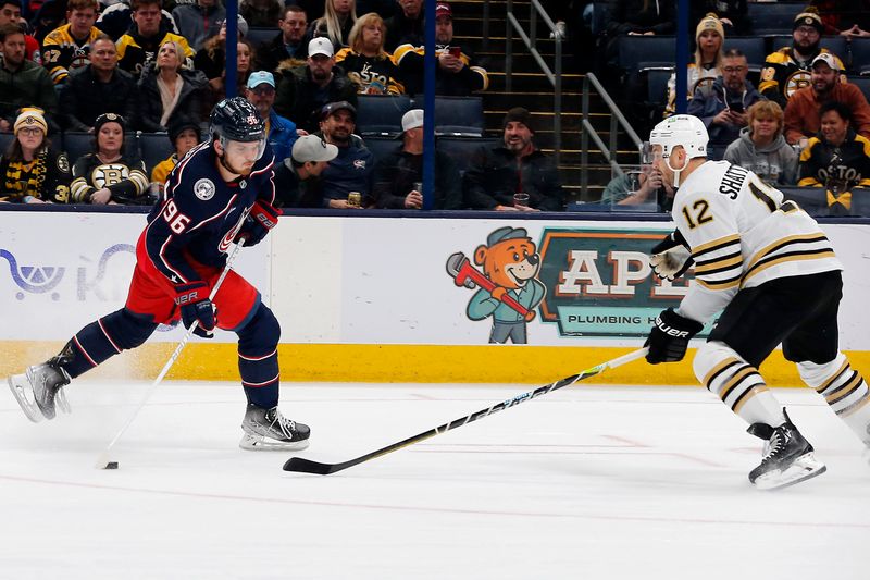 Jan 2, 2024; Columbus, Ohio, USA; Columbus Blue Jackets center Jack Roslovic (96) wrists a shot on goal as Boston Bruins defenseman Kevin Shattenkirk (12) defends during the first period at Nationwide Arena. Mandatory Credit: Russell LaBounty-USA TODAY Sports