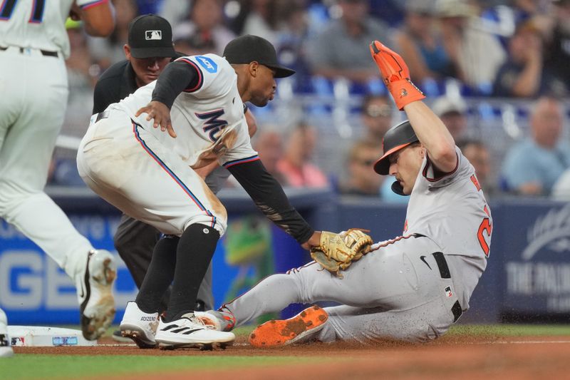 Jul 25, 2024; Miami, Florida, USA;  Baltimore Orioles shortstop Gunnar Henderson (2) is tagged out in a rundown by Miami Marlins shortstop Xavier Edwards (63) in the fourth inning by at loanDepot Park. Mandatory Credit: Jim Rassol-USA TODAY Sports
