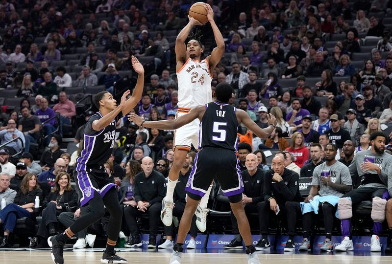 SACRAMENTO, CALIFORNIA - MARCH 07: Devin Vassell #24 of the San Antonio Spurs shoots over De'Aaron Fox #5 and Keegan Murray #13 of the Sacramento Kings during the first half at Golden 1 Center on March 07, 2024 in Sacramento, California. NOTE TO USER: User expressly acknowledges and agrees that, by downloading and or using this photograph, User is consenting to the terms and conditions of the Getty Images License Agreement. (Photo by Thearon W. Henderson/Getty Images)