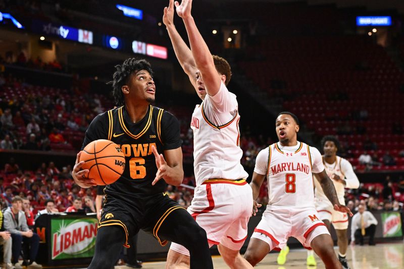 Feb 11, 2026; College Park, Maryland, USA;  Iowa Hawkeyes guard Tavion Banks (#6) looks for room to shoot under the basket in the first half against the Maryland Terrapins at Xfinity Center. Mandatory Credit: Jamie Sabau-Imagn Images