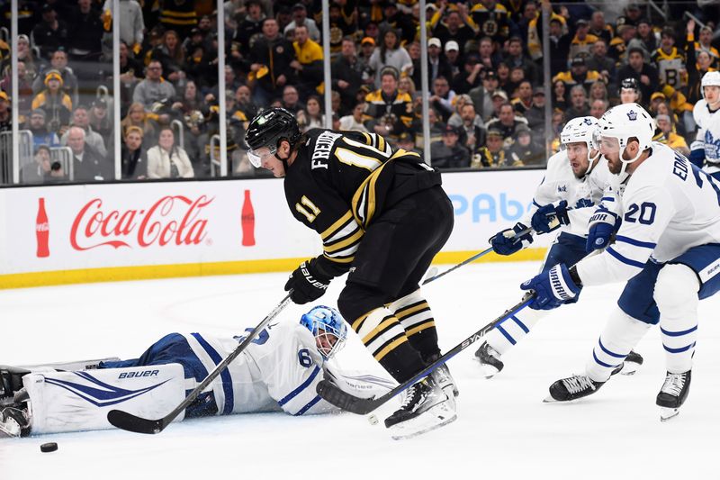 Apr 30, 2024; Boston, Massachusetts, USA; Boston Bruins center Trent Frederic (11) looks for a rebound in front of Toronto Maple Leafs goaltender Joseph Woll (60) during the third period in game five of the first round of the 2024 Stanley Cup Playoffs at TD Garden. Mandatory Credit: Bob DeChiara-USA TODAY Sports