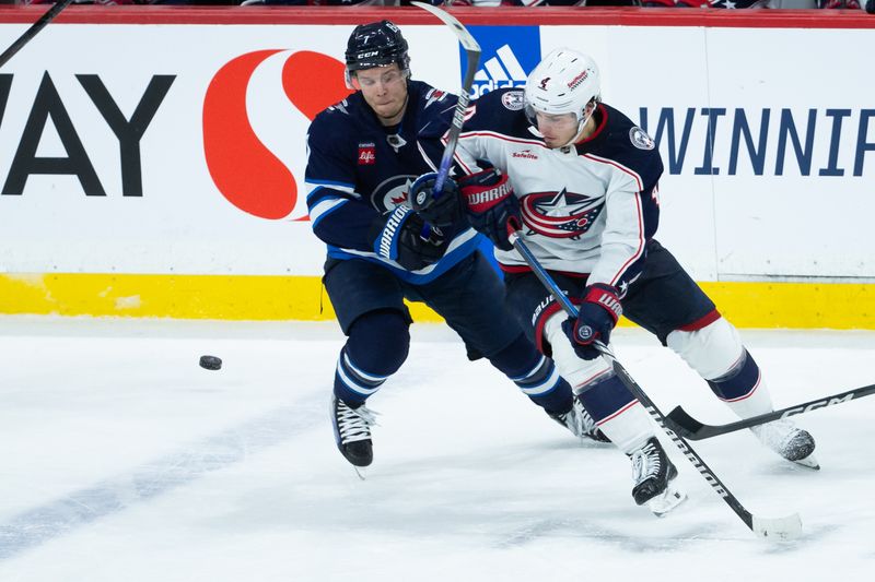 Jan 9, 2024; Winnipeg, Manitoba, CAN; Winnipeg Jets forward Vladislav Namestnikov (7) checks Columbus Blue Jackets forward Cole Sillinger (4) during the third period at Canada Life Centre. Mandatory Credit: Terrence Lee-USA TODAY Sports