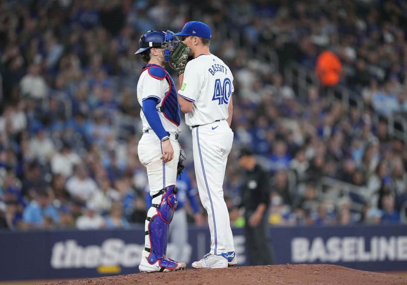 May 1, 2024; Toronto, Ontario, CAN; Toronto Blue Jays catcher Danny Jansen (9) talks with starting pitcher Chris Bassitt (40) against the Kansas City Royals during the fifth inning at Rogers Centre. Mandatory Credit: Nick Turchiaro-USA TODAY Sports