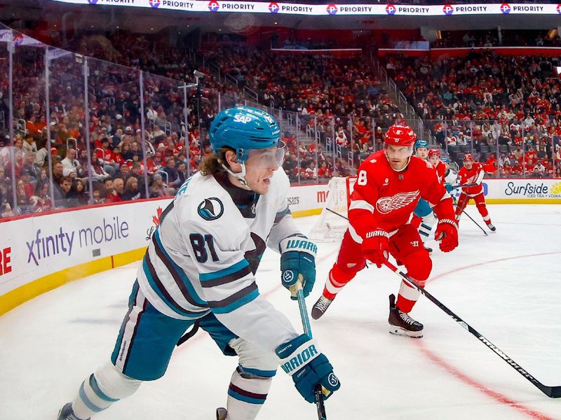 Jan 16, 2026; Detroit, Michigan, USA; San Jose Sharks right wing Adam Gaudette (81) handles the puck against Detroit Red Wings defenseman Ben Chiarot (8) during the first period at Little Caesars Arena. Mandatory Credit: Brian Bradshaw Sevald-Imagn Images