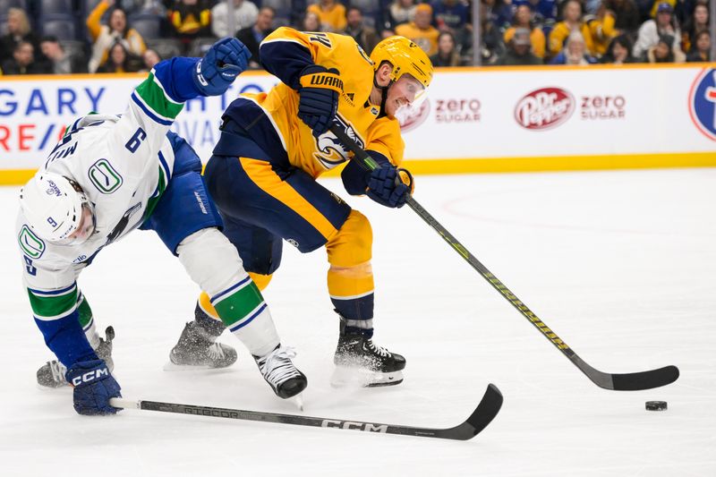 Jan 29, 2025; Nashville, Tennessee, USA;  Vancouver Canucks center J.T. Miller (9) and Nashville Predators center Gustav Nyquist (14) battle for the puck during the third period at Bridgestone Arena. Mandatory Credit: Steve Roberts-Imagn Images