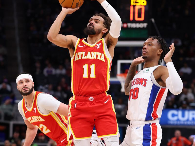 DETROIT, MICHIGAN - FEBRUARY 03: Trae Young #11 of the Atlanta Hawks takes a shot next to Ronald Holland II #00 of the Detroit Pistons during the first half at Little Caesars Arena on February 03, 2025 in Detroit, Michigan. NOTE TO USER: User expressly acknowledges and agrees that, by downloading and or using this photograph, User is consenting to the terms and conditions of the Getty Images License. (Photo by Gregory Shamus/Getty Images)