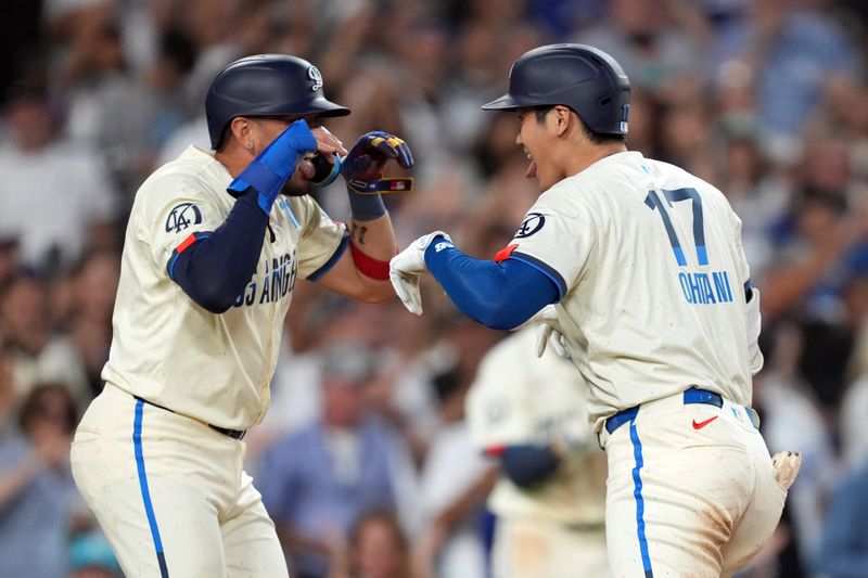 Aug 24, 2024; Los Angeles, California, USA; Los Angeles Dodgers designated hitter Shohei Ohtani (17) celebrates with shortstop Miguel Rojas (11) after hitting a two-run home run in the fifth inning against the Tampa Bay Rays at Dodger Stadium. Mandatory Credit: Kirby Lee-USA TODAY Sports