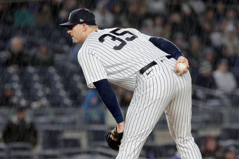 May 3, 2023; Bronx, New York, USA; New York Yankees relief pitcher Clay Holmes (35) looks in for a sign in the rain during the ninth inning against the Cleveland Guardians at Yankee Stadium. Mandatory Credit: Brad Penner-USA TODAY Sports