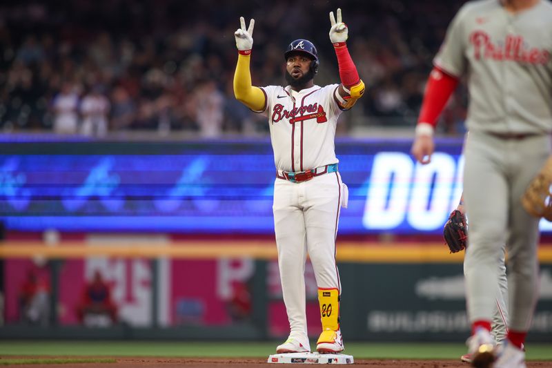 Apr 10, 2025; Atlanta, Georgia, USA; Atlanta Braves designated hitter Marcell Ozuna (20) celebrates after a double against the Philadelphia Phillies in the first inning at Truist Park. Mandatory Credit: Brett Davis-Imagn Images
