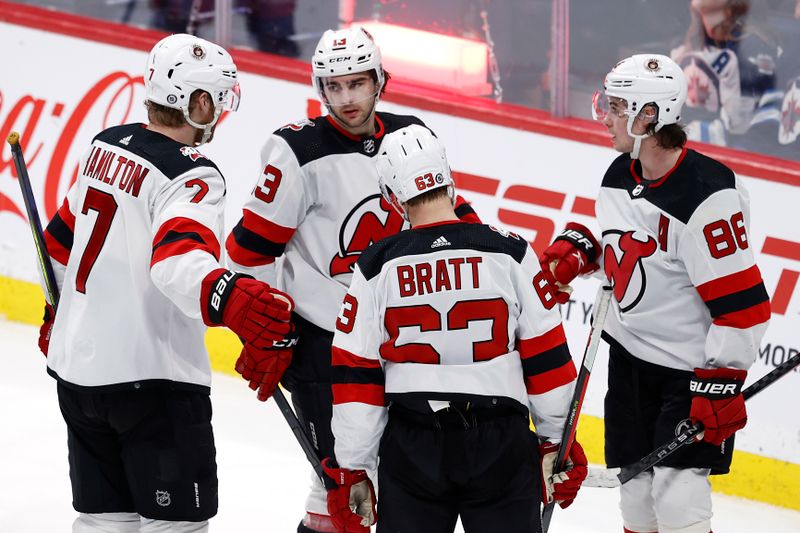 Apr 2, 2023; Winnipeg, Manitoba, CAN; New Jersey Devils center Nico Hischier (13) celebrates his third period goal against the Winnipeg Jets at Canada Life Centre. Mandatory Credit: James Carey Lauder-USA TODAY Sports