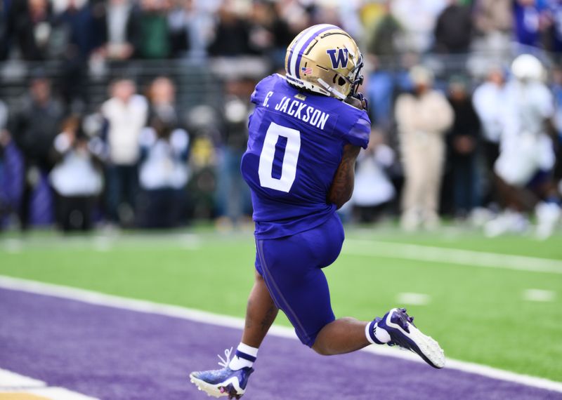 Oct 14, 2023; Seattle, Washington, USA; Washington Huskies wide receiver Giles Jackson (0) catches a pass for a touchdown against the Oregon Ducks during the first half at Alaska Airlines Field at Husky Stadium. Mandatory Credit: Steven Bisig-USA TODAY Sports