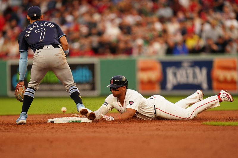 May 13, 2024; Boston, Massachusetts, USA; Boston Red Sox third baseman Rafael Devers (11) hits a double to right field against the Tampa Bay Rays in the first inning at Fenway Park. Mandatory Credit: David Butler II-USA TODAY Sports