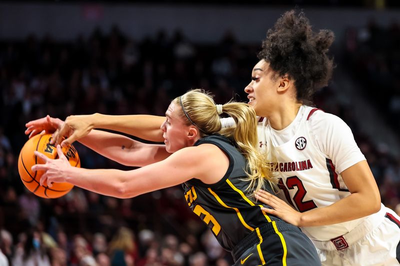 Jan 15, 2023; Columbia, South Carolina, USA; Missouri Tigers guard Haley Troup (13) and South Carolina Gamecocks guard Brea Beal (12) battle for a loose ball in the first half at Colonial Life Arena. Mandatory Credit: Jeff Blake-USA TODAY Sports