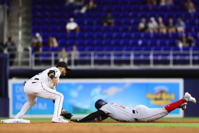 Apr 29, 2024; Miami, Florida, USA; Miami Marlins second baseman Luis Arraez (3) tags out Washington Nationals second baseman Ildemaro Vargas (14) during the sixth inning at loanDepot Park. Mandatory Credit: Sam Navarro-USA TODAY Sports