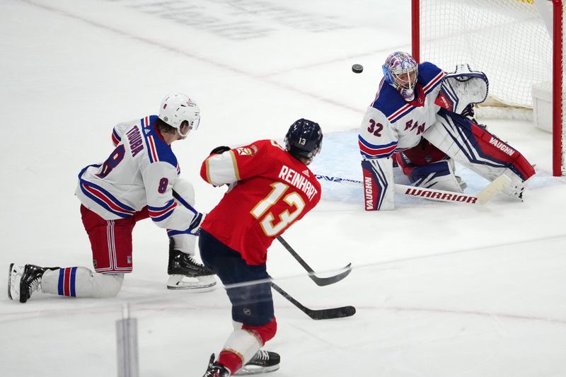 Dec 29, 2023; Sunrise, Florida, USA; New York Rangers goaltender Jonathan Quick (32) blocks the shot of Florida Panthers center Sam Reinhart (13) during the second period at Amerant Bank Arena. Mandatory Credit: Jasen Vinlove-USA TODAY Sports