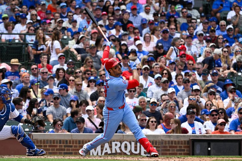 Jun 15, 2024; Chicago, Illinois, USA;  St. Louis Cardinals third base Nolan Arenado (28) hits an RBI sacrifice fly ball against the Chicago Cubs during the fourth inning at Wrigley Field. Mandatory Credit: Matt Marton-USA TODAY Sports