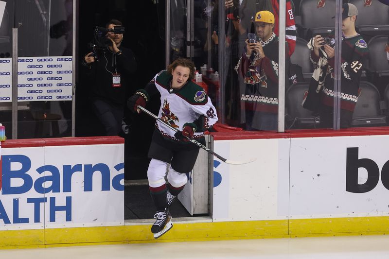 Oct 13, 2023; Newark, New Jersey, USA; Arizona Coyotes center Logan Cooley (92) takes his rookie lap before the start of his first NHL game against the New Jersey Devils at Prudential Center. Mandatory Credit: Ed Mulholland-USA TODAY Sports