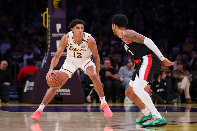 LOS ANGELES, CALIFORNIA - DECEMBER 08: Max Christie #12 of the Los Angeles Lakers handles the ball defended by Anfernee Simons #1 of the Portland Trail Blazers in the second half at Crypto.com Arena on December 08, 2024 in Los Angeles, California. NOTE TO USER: User expressly acknowledges and agrees that, by downloading and or using this Photograph, user is consenting to the terms and conditions of the Getty Images License Agreement. (Photo by Meg Oliphant/Getty Images)