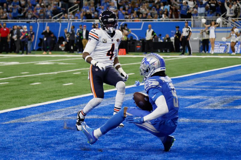 Detroit Lions wide receiver Jameson Williams (9), defended by Chicago Bears safety Eddie Jackson (4), falls into the endzone after a 32-reception for a touchdown during the second half of an NFL football game, Sunday, Nov. 19, 2023, in Detroit. (AP Photo/Duane Burleson)