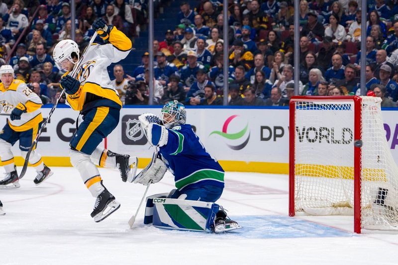 Apr 30, 2024; Vancouver, British Columbia, CAN; Nashville Predators forward Luke Evangelista (77) redirects a shot in front of Vancouver Canucks goalie Arturs Silvos (31) during the second period in game five of the first round of the 2024 Stanley Cup Playoffs at Rogers Arena. Mandatory Credit: Bob Frid-USA TODAY Sports