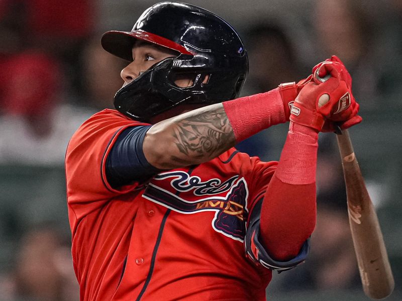 May 19, 2023; Cumberland, Georgia, USA; Atlanta Braves shortstop Orlando Arcia (11) singles to drive in a run against the Seattle Mariners during the seventh inning at Truist Park. Mandatory Credit: Dale Zanine-USA TODAY Sports