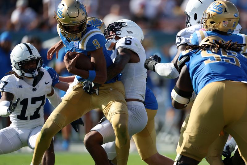 Oct 4, 2025; Pasadena, California, USA; Penn State Nittany Lions safety Zakee Wheatley (6) sacks UCLA Bruins quarterback Nico Iamaleava (9) during the fourth quarter at Rose Bowl. Mandatory Credit: Kiyoshi Mio-Imagn Images