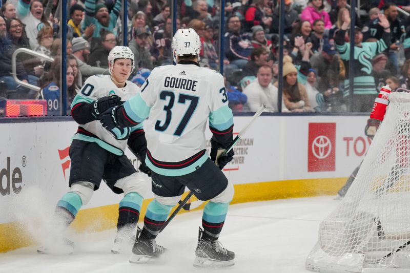 cJan 13, 2024; Columbus, Ohio, USA;  Seattle Kraken right wing Eeli Tolvanen (20) celebrates with center Yanni Gourde (37) after scoring an empty net goal against the Columbus Blue Jackets in the third period at Nationwide Arena. Mandatory Credit: Aaron Doster-USA TODAY Sports