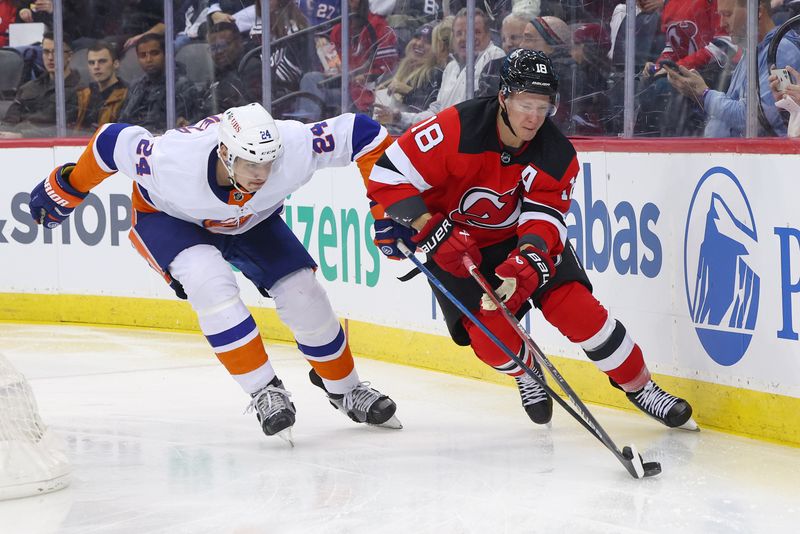 Nov 28, 2023; Newark, New Jersey, USA; New Jersey Devils left wing Ondrej Palat (18) skates with the puck while being defended by New York Islanders defenseman Scott Mayfield (24) during the second period at Prudential Center. Mandatory Credit: Ed Mulholland-USA TODAY Sports